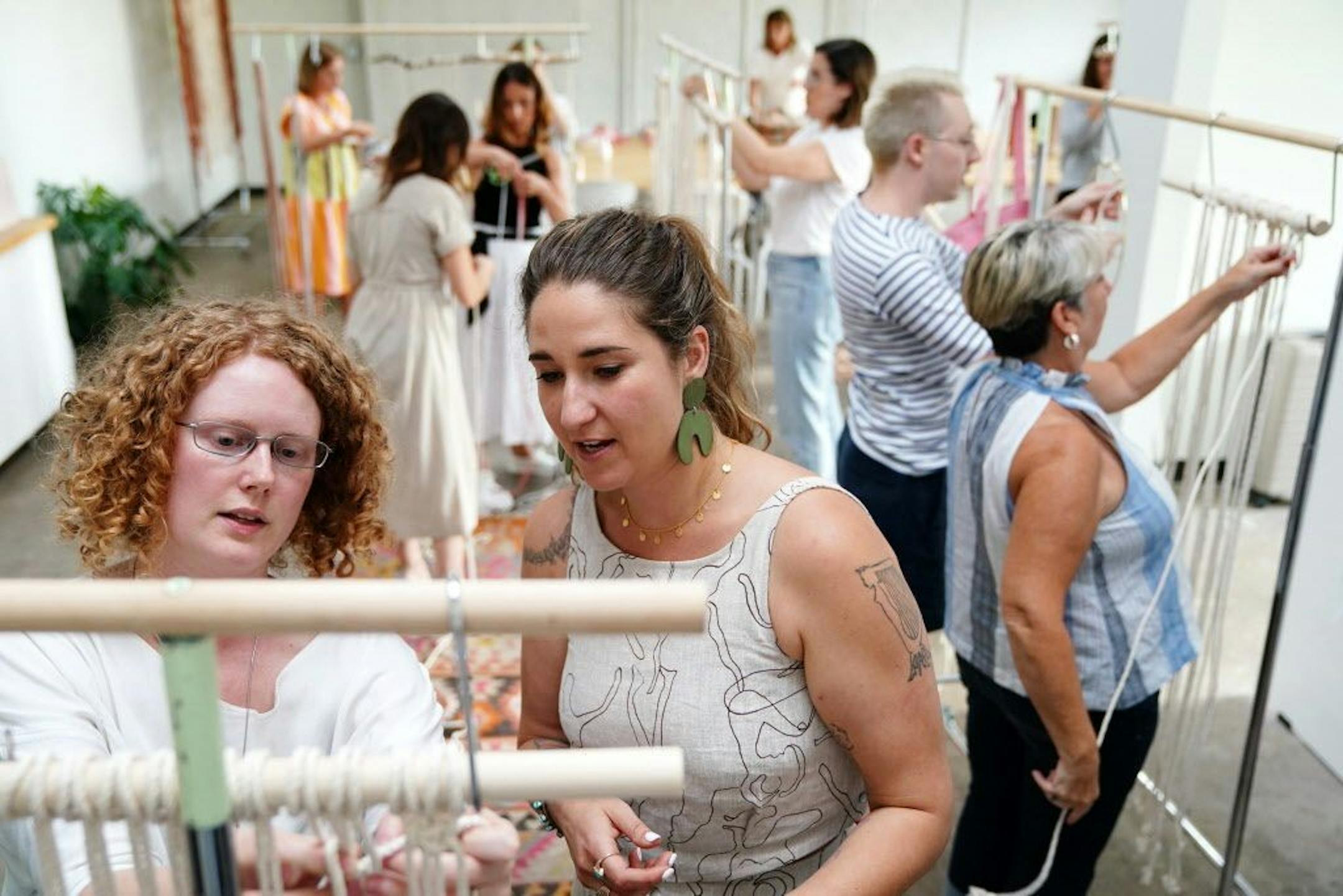 Emily Katz helped Ariane Laxo with her macrame project during the class.