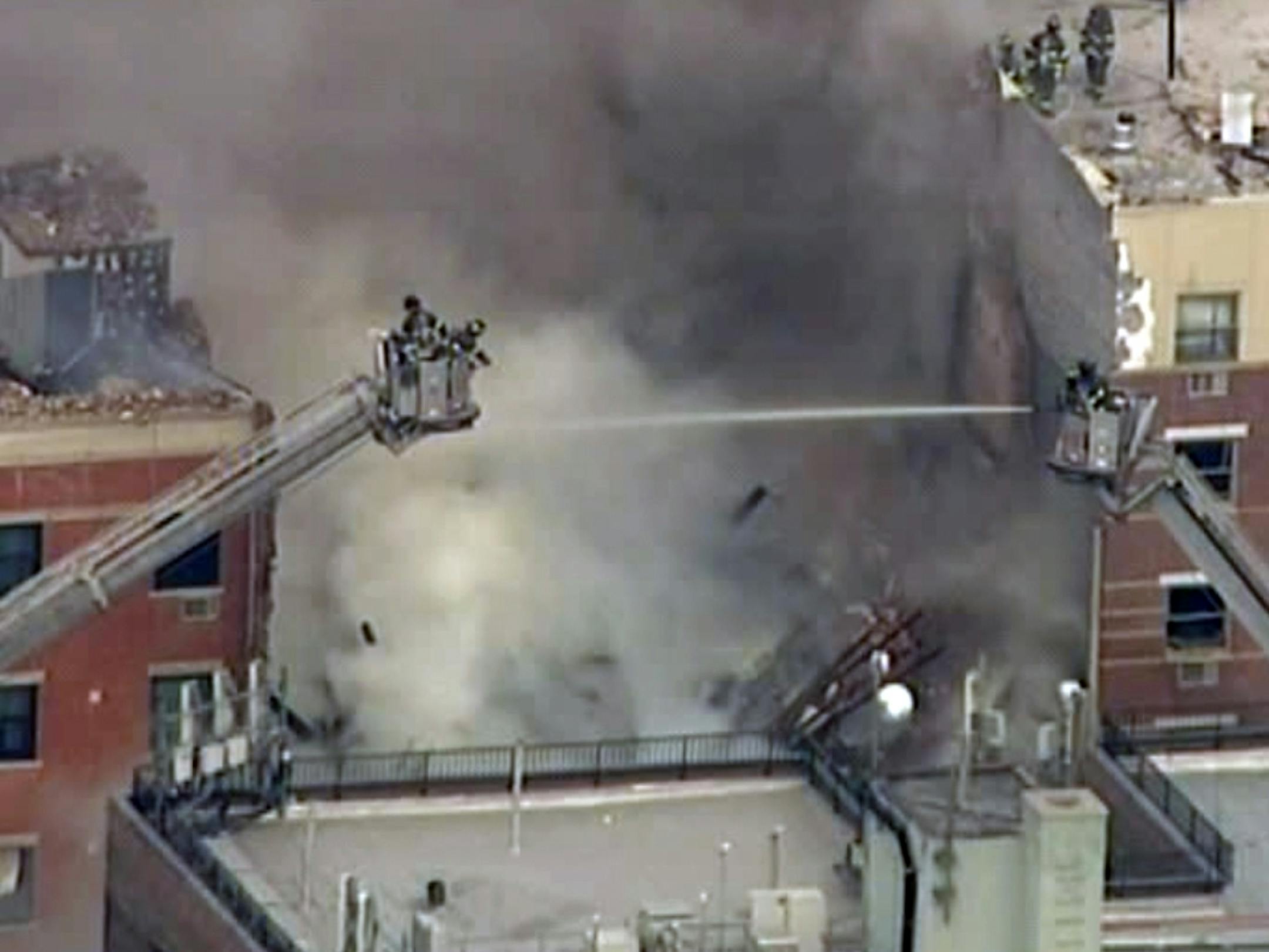 In this image taken from video from WABC, firefighters battle a blaze at the site of a possible explosion and building collapse in the East Harlem neighborhood of New York, Wednesday, March 12, 2014.