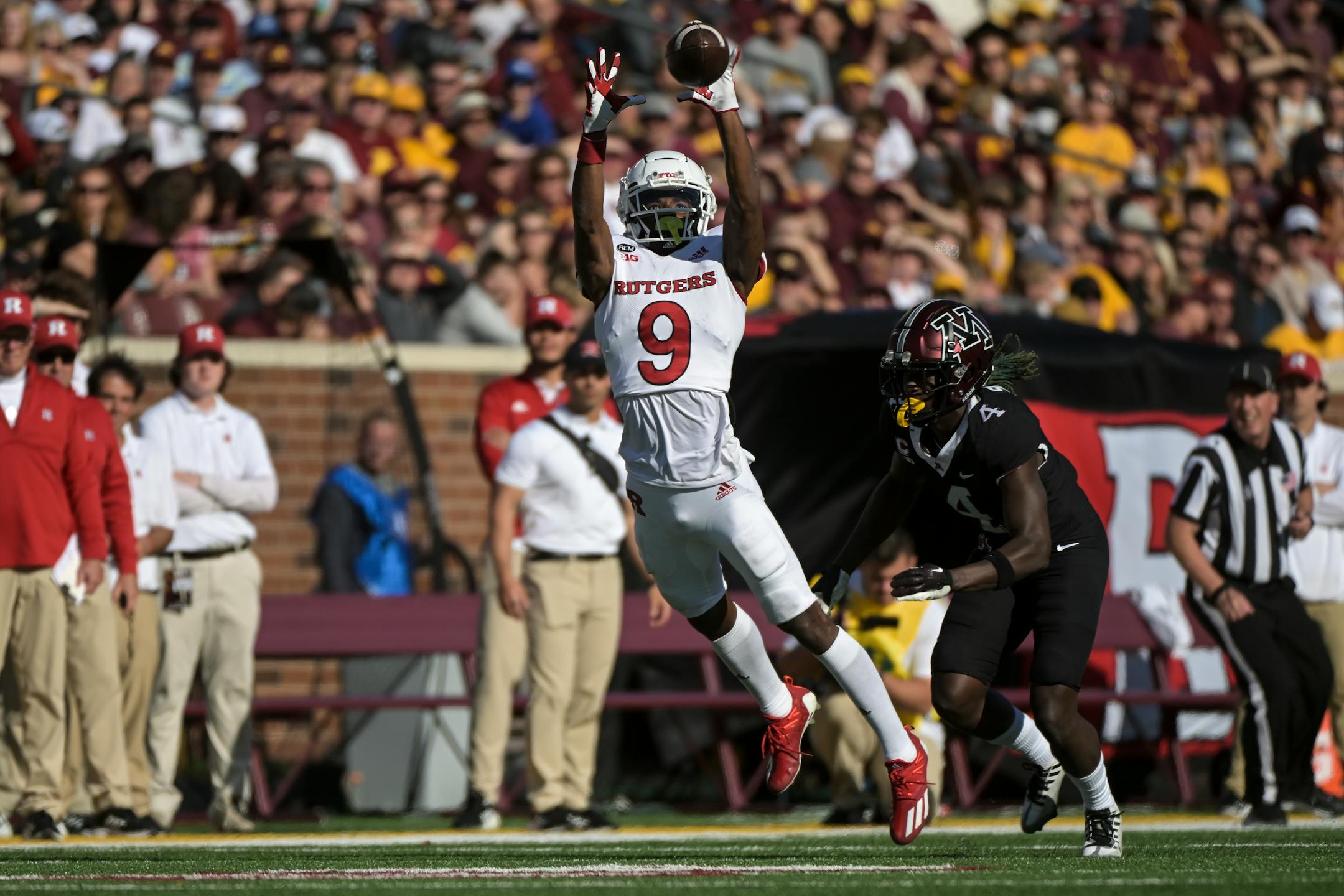 Rutgers Scarlet Knights wide receiver Chris Long (9) catches a pass for nine yards as he's defended by Minnesota Golden Gophers defensive back Terell Smith (4).