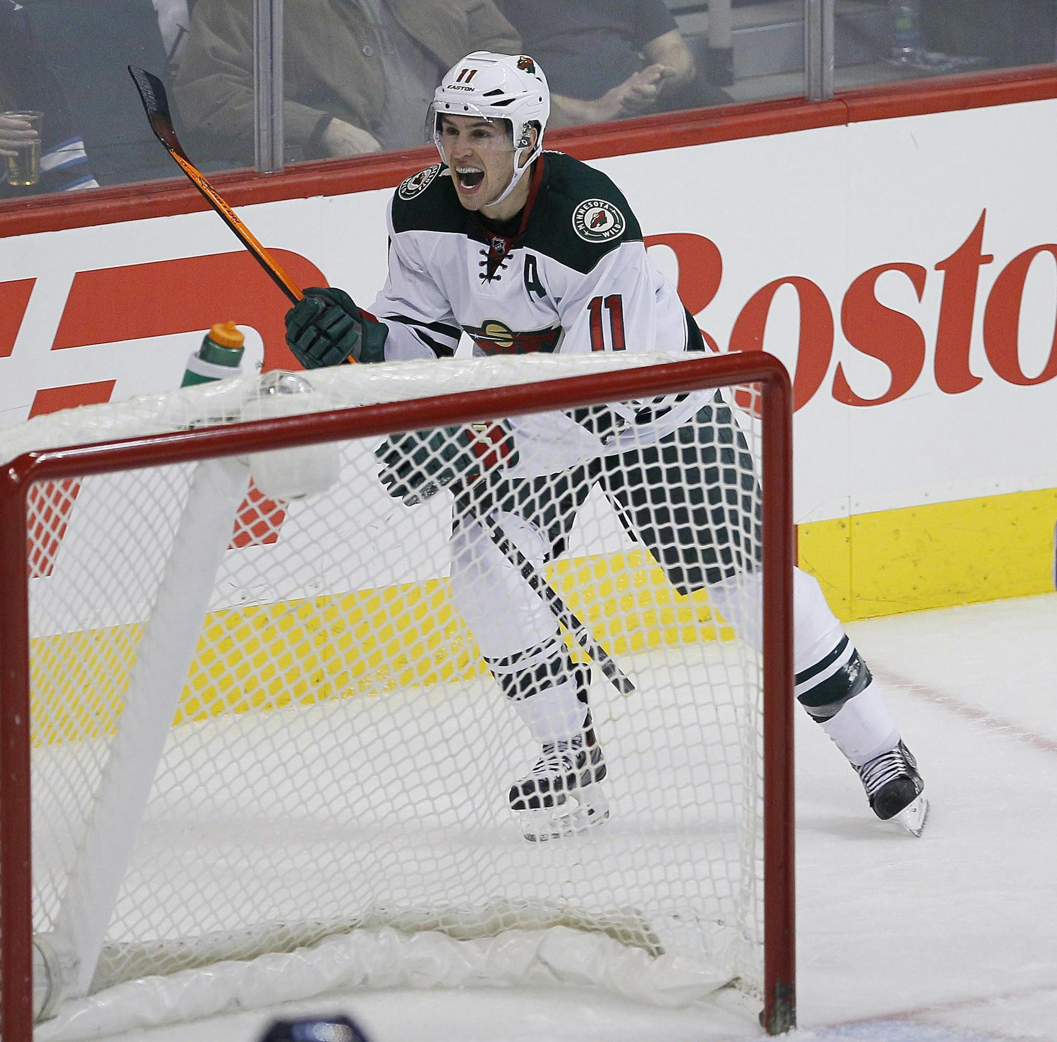 Minnesota Wild's Zach Parise (11) celebrates his goal against Winnipeg Jets' goaltender Ondrej Pavelec (31) during the third period of an NHL game in Winnipeg, Manitoba, Saturday, Nov. 23, 2013. (AP Photo/The Canadian Press, John Woods)