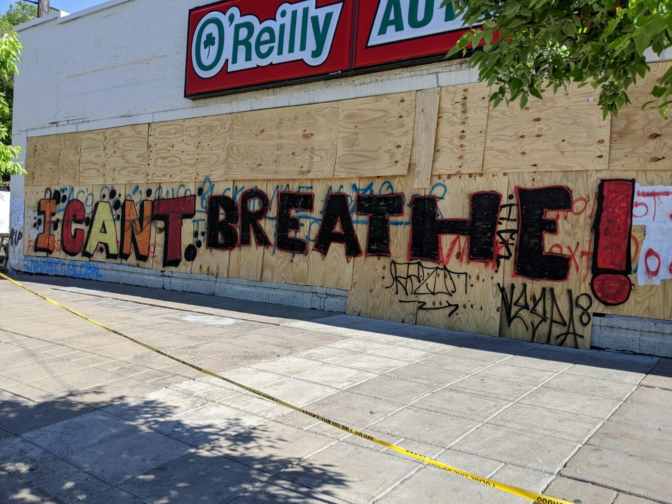 A group of artists who preferred to be anonymous tagged the boarded-up windows of O'Reilly Auto Parts at 2905 E. Lake St., using art to express outrage over George Floyd's death in police custody.