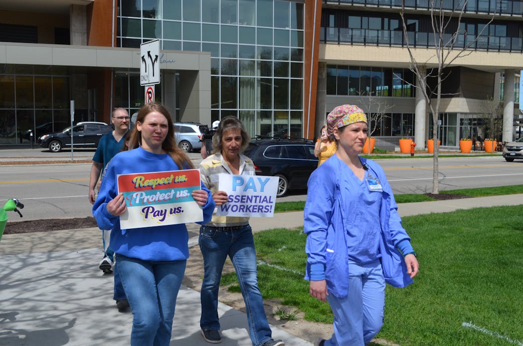 Union workers at St. Marys Hospital in Rochester deliver a petition to hospital leaders on May 8, urging them to consider better wages, less mandatory overtime and safer workloads for almost 1,600 SEIU members at the hospital.
