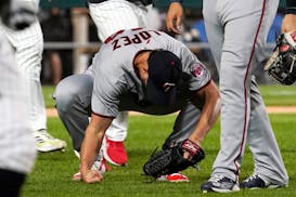 Minnesota Twins relief pitcher Jorge Lopez reacts after the team's 4-3 loss to the Chicago White Sox in a baseball game in Chicago, Friday, Sept. 2, 2