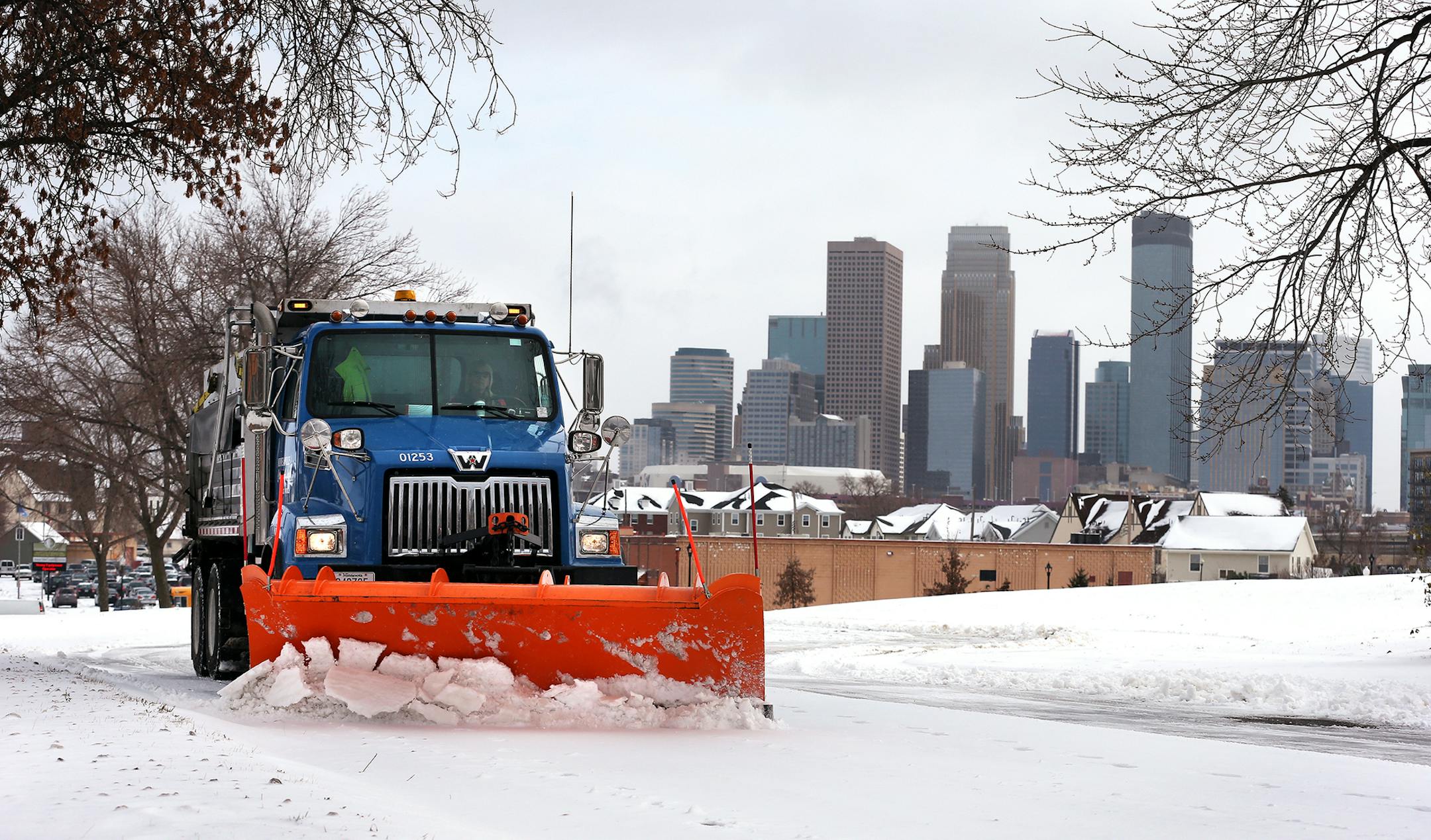 City of Minneapolis truck driver Vicky Stich plows snow and lays down sand and salt on Olson Highway Service Road in Minneapolis on Tuesday, November 11, 2014. Stich has been driving a truck for the city for 38 years.