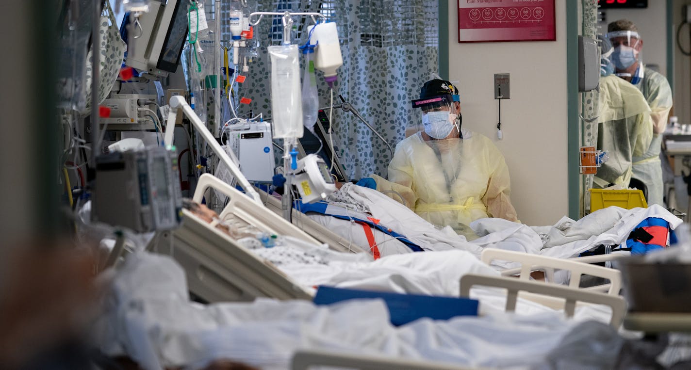 FILE -- A Hospital worker cares for a patients with the coronavirus at Elmhurst Hospital in Queens, May 8, 2020. A single infusion of an experimental drug, a monoclonal antibody, has markedly reduced blood levels of the coronavirus in newly infected patients and lowered the chances that they would need hospitalization, the drug's maker, Eli Lilly, announced on Wednesday, Sept. 16, 2020. (Erin Schaff/The New York Times)