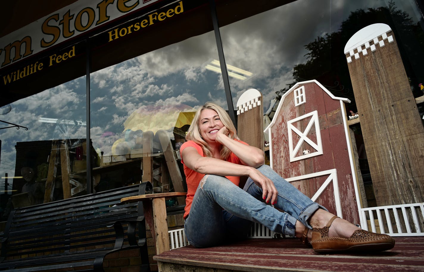 Rebecca Kolls reclines outside her store, a mainstay on Stillwater's Main Street.