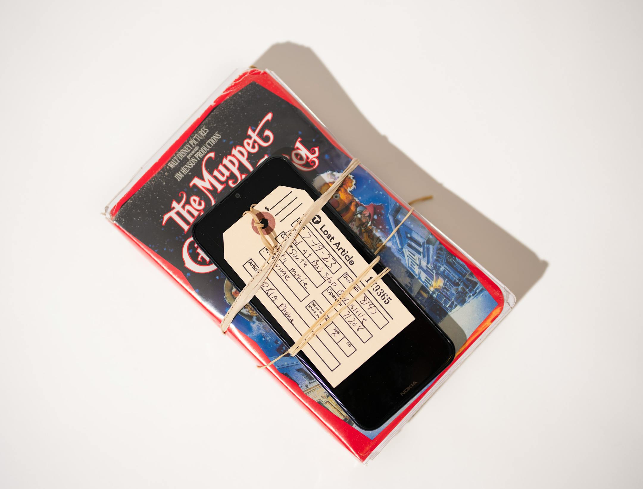 A movie and a mobile phone left behind at a Metro Transit bus stop recently, photographed in the Lost and Found room.