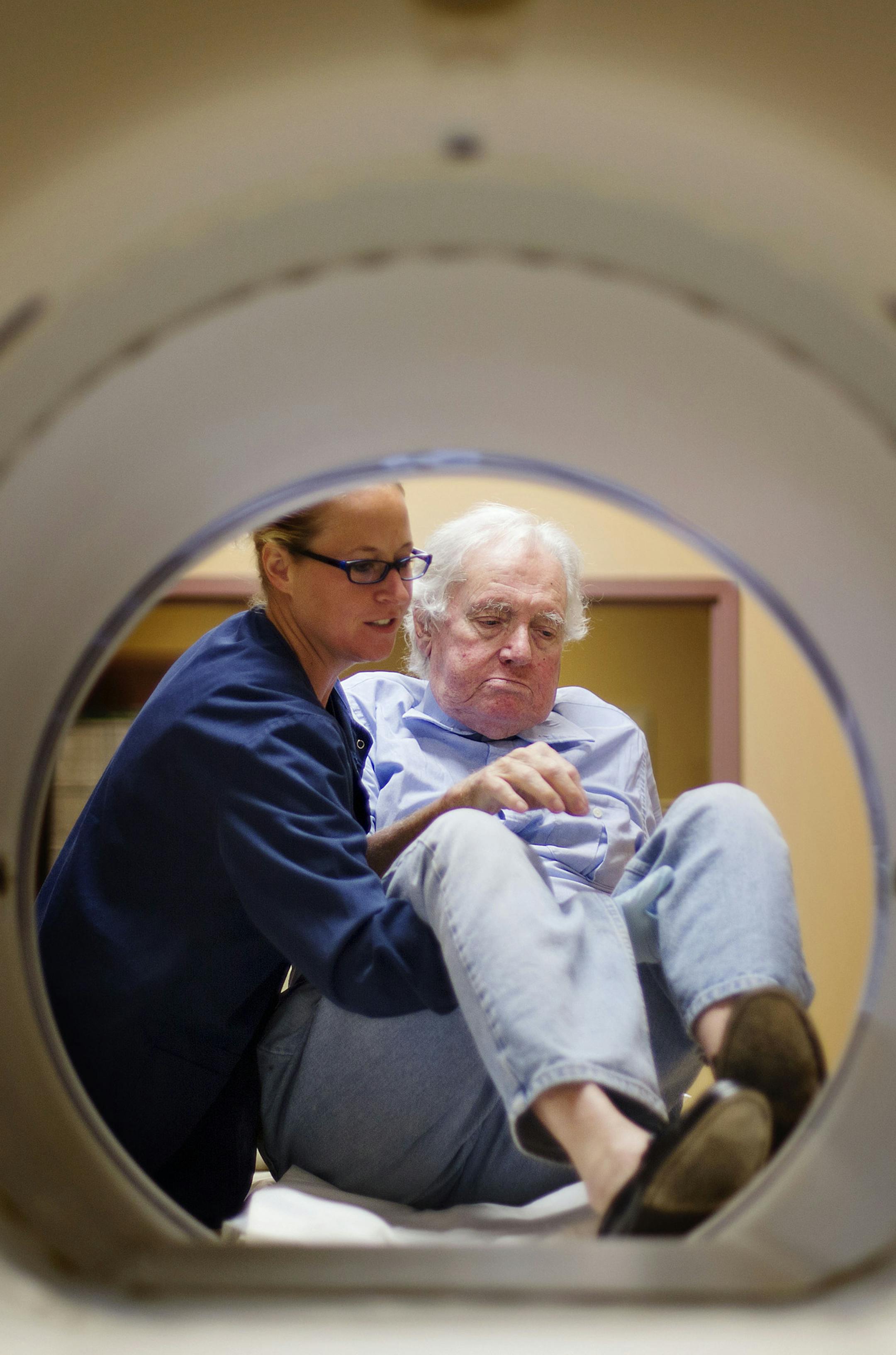 ADVANCE FOR USE MONDAY, NOV. 16 - In this photo taken Aug. 27, 2015, John Jay Hooker, right, is helped off the table by technician Karen Wood after a CT scan that will reveal whether his cancer treatments are working in Nashville, Tenn. At a legislative hearing this summer for a physician-assisted suicide bill, Hooker spoke from a wheelchair and at times struggled to catch his breath. The following month, at a court hearing on the issue, Hooker was shaky but standing. And afterward he told repor