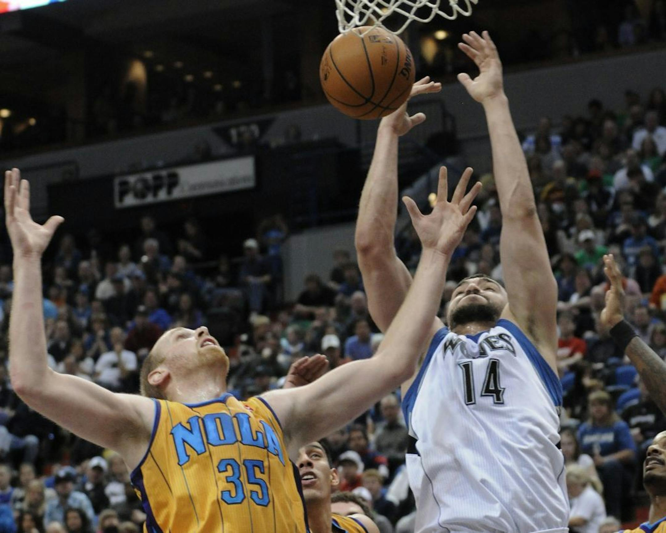 New Orleans Hornets' Chris Kaman, left, and Minnesota Timberwolves' Nikola Pekovic, of Montenegro, compete for the rebound in the first half of an NBA basketball game, Saturday, March 10, 2012, in Minneapolis.