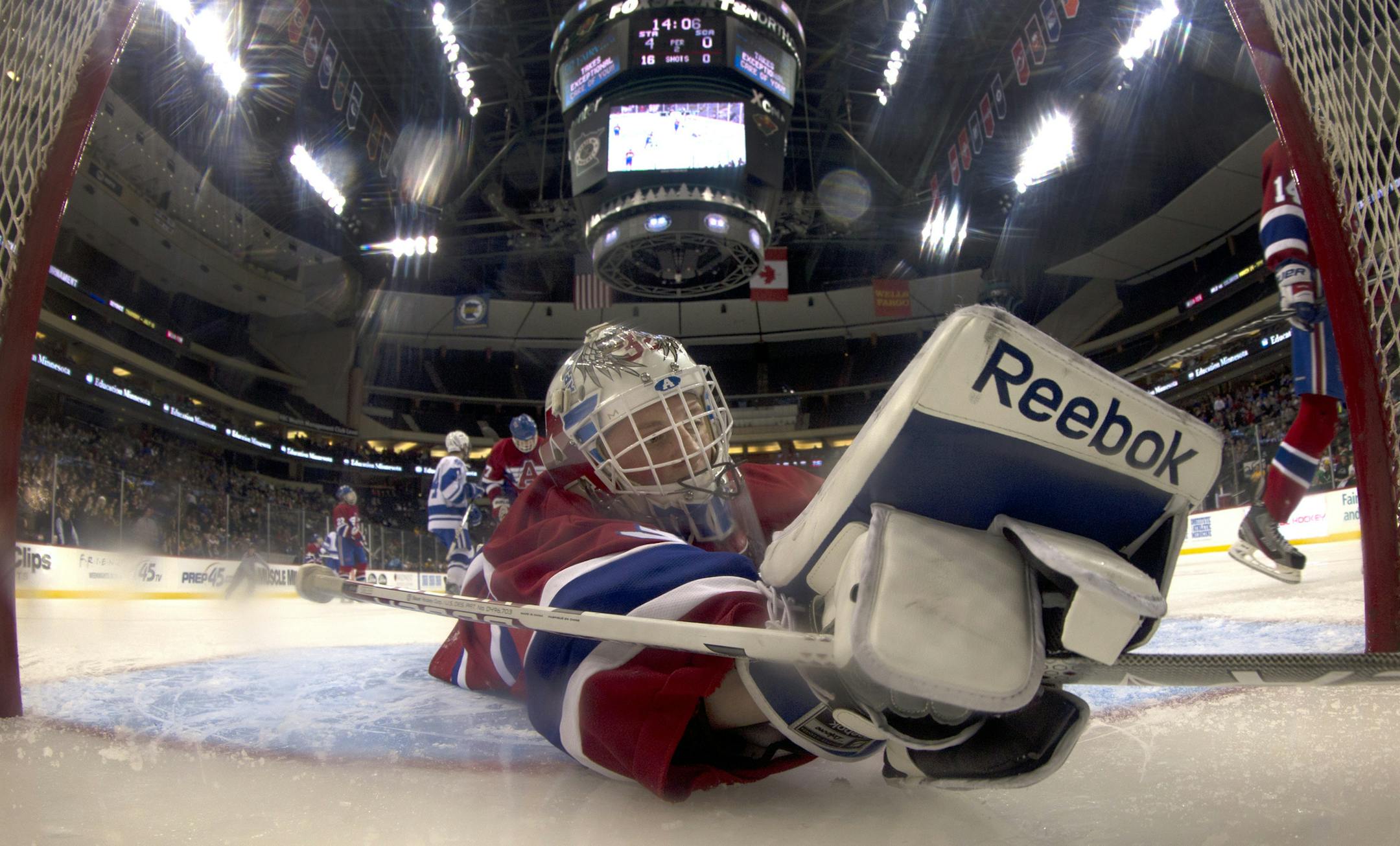 St. Cloud Apollo goalie Nick Althaus (32) could not stop a shot by Wyatt Schmidt (4) of St. Thomas Academy for a goal in the second period. STA beat St. Cloud Apollo by a final score of 12-0. ] CARLOS GONZALEZ cgonzalez@startribune.com - March 6, 2013, St. Paul, Minn., Xcel Energy Center, Minnesota High School Boys State Hockey Tournament, St. Cloud Apollo vs. St. Thomas Academy