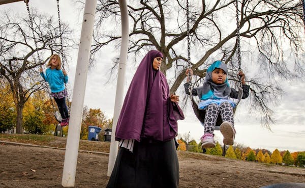 Faisa Adeys pushed her 2-year-old daughter Mumtaz in a swing in Matthews Park, Minneapolis.