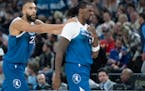 Rudy Gobert (27) grabs Naz Reid's shoulders after Reid hit a three-pointer during a Timberwolves game in March.
