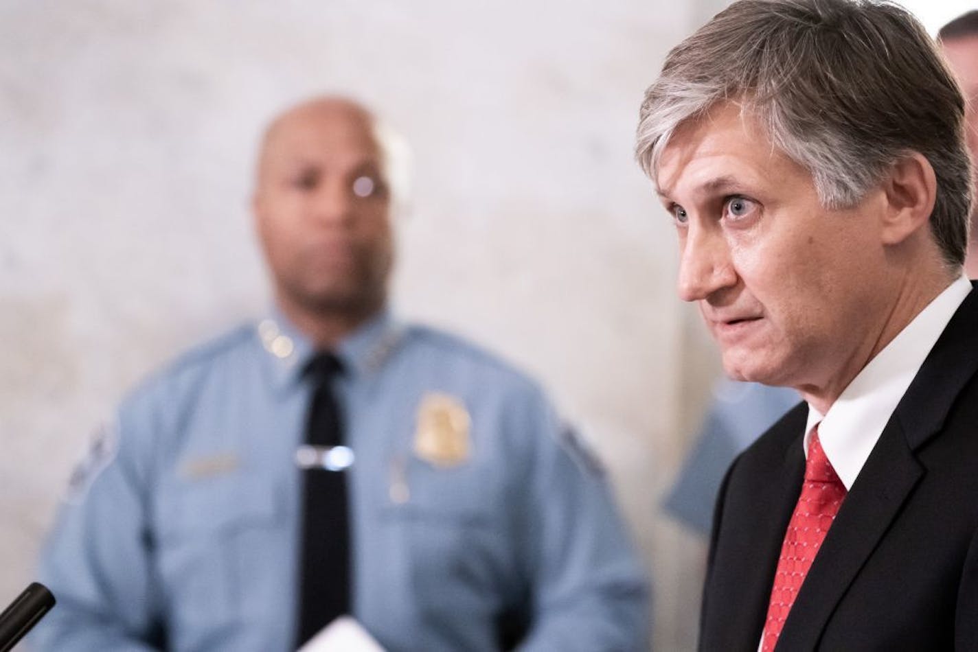 Tom Arneson, managing attorney for the Hennepin County Attorney's Office juvenile division, spoke at a press conference to announce the arrest of a suspect in the 2015 murder of Susan Spiller. Minneapolis Police Chief Medaria Arradondo listened.