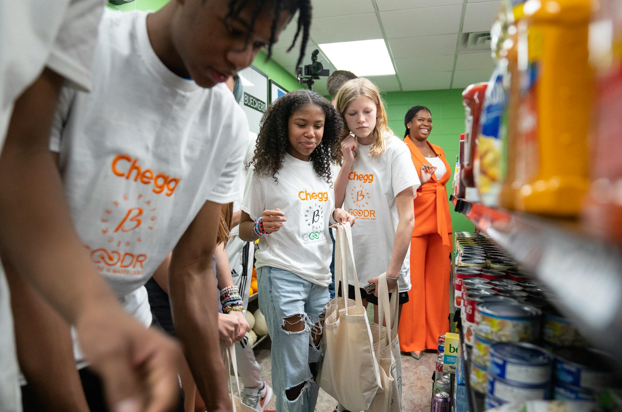 Students shop for free food during the grand opening of a new free grocery store.