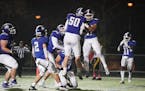 Woodbury running back Isaiah Tisdle (21) and offensive lineman Keaton Brown (50) celebrated Tisdle's third quarter touchdown against Burnsville.