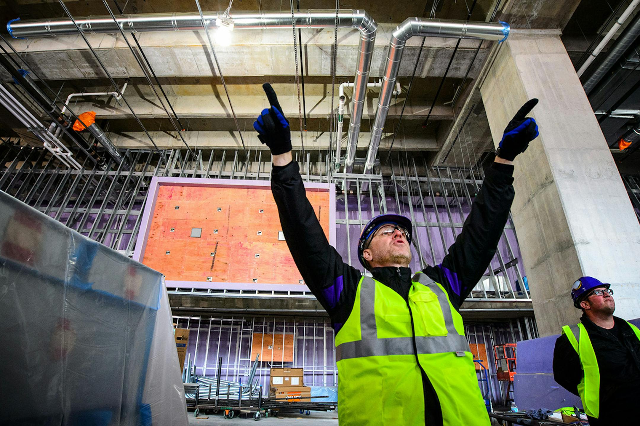 J.P. Paul, Vikings director for new stadium corporate development, pointed out where the flat screen monitors would be positioned in front of him and on the mount behind him in the Valhalla Club level. Thursday, May 14, 2015 Construction update of the new Vikings stadium, Minneapolis, MN