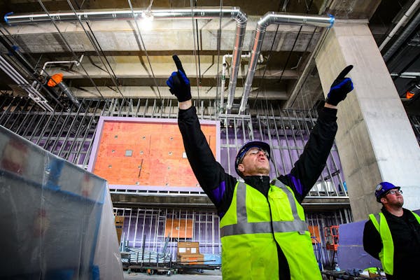 J.P. Paul, Vikings director for new stadium corporate development, pointed out where the flat screen monitors would be positioned in front of him and 