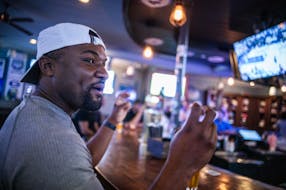 Da-Shon Dixon, who attended law school at Georgia, keeps an eye on game 4 of the Timberwolves against the Nuggets at Irby’s Tavern  in Atlanta on Su