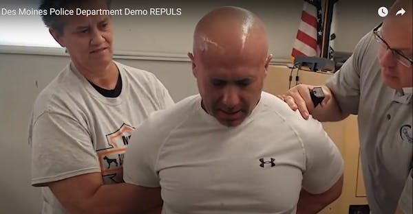 Officers at the Des Moines Police Department demonstrate how REPULS, an alternative chemical irritant to pepper spray, can be used to subdue an attack