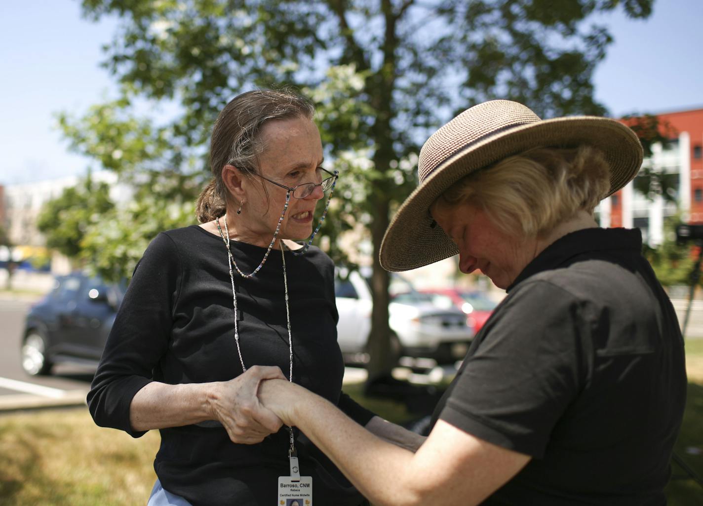 Nurse-midwife Rebeca Barroso, left, comforted nurse Chris Weimholt on her last day of work at the Seton Prenatal Clinic in St. Paul.