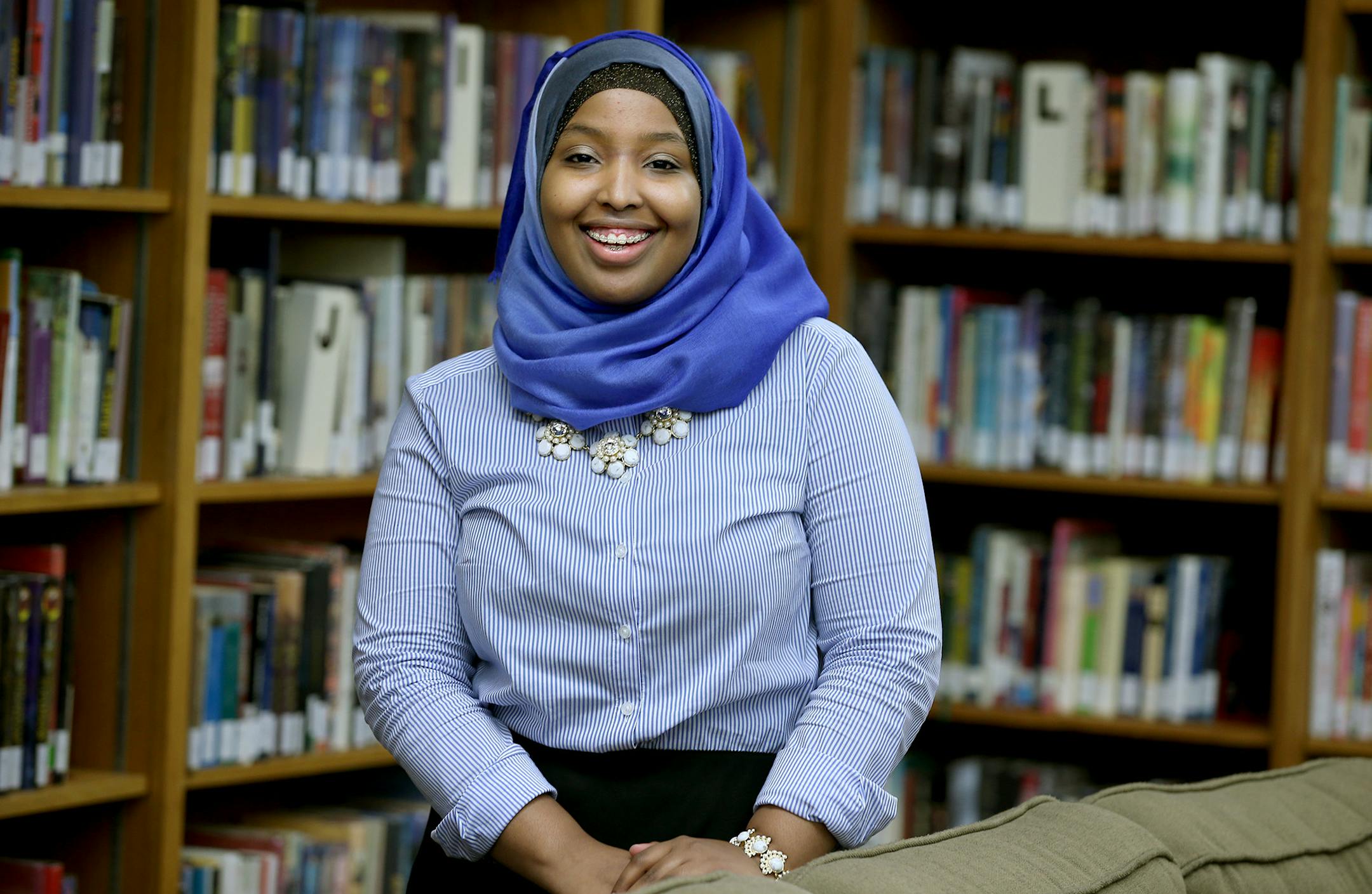 Munira Khalif stood in the Mounds Park Academy Library, Thursday, October 23, 2014 in St. Paul, MN. Khalif, a 17-year-old senior, founded a nonprofit and lobbied for legislation against child marriage and help build new libraries in Somalia. She even performed her spoken-word poetry for United Nations leaders and recent Nobel Prize-winner Malala Yousafzai. ] (ELIZABETH FLORES/STAR TRIBUNE) ELIZABETH FLORES • eflores@startribune.com
