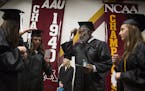 Bobby Bell fixed his tassel with some of his fellow graduating students as they lined up for the procession before Thursday&#x2019;s University of Min