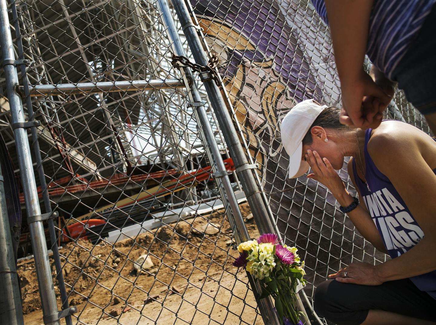 At US Bank Stadium, one worker was killed and another injured in a construction site accident earlier this morning. Angela Strong and daughter Kyra,11, of St. Paul brought a bouquet of flowers and said prayers for the construction workers. "We forget how much danger is involved (in construction), " said Angela.] Richard Tsong-Taatarii/rtsong-taatarii@startribune.com