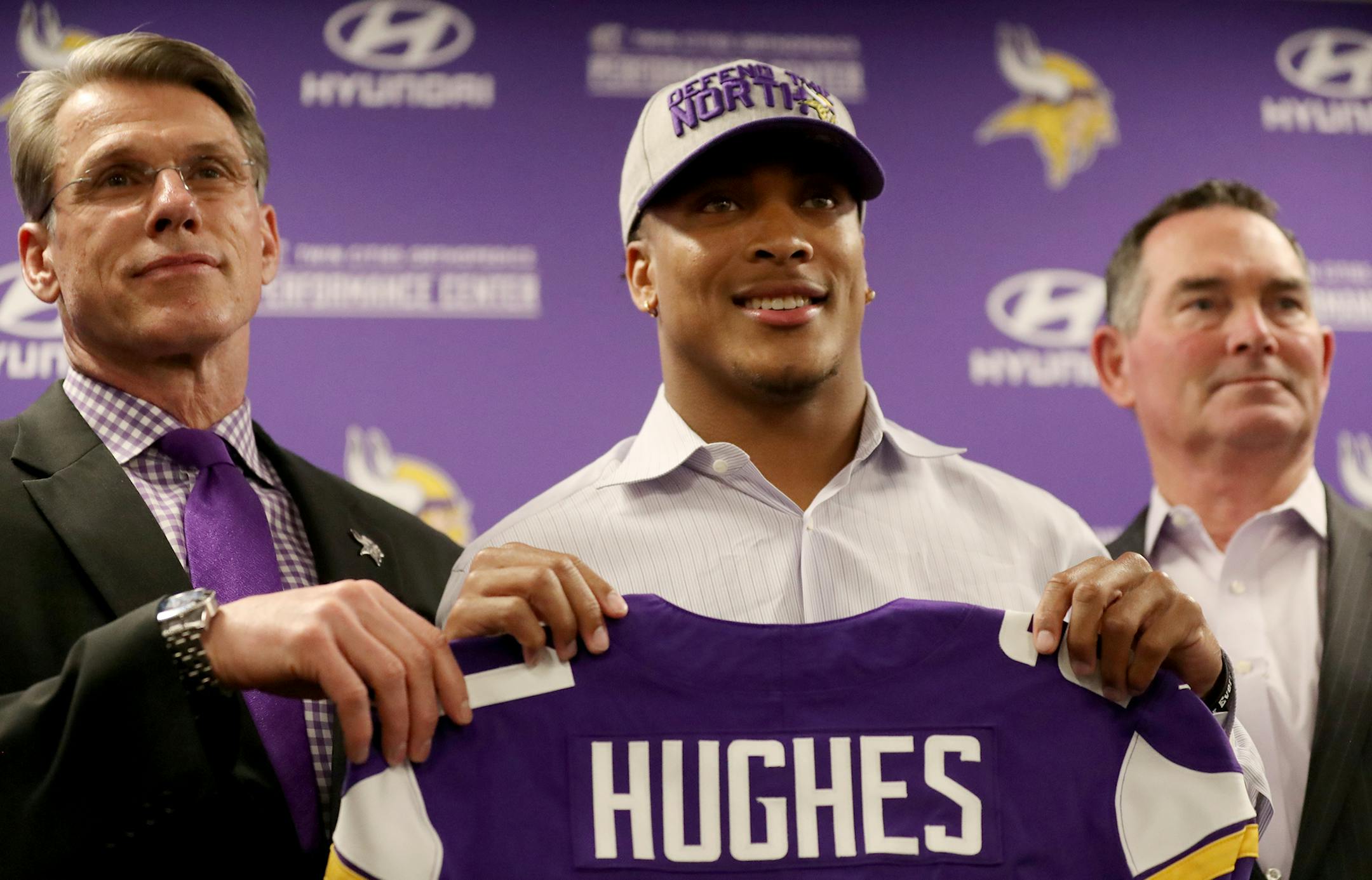Minnesota Vikings first-round pick cornerback Mike Hughes from the University of Central Florida, with Vikings general manager Rick Spielman, left, and Vikings head coach Mike Zimmer, right, during a news conference on Friday, April 27, 2018, at the Twin Cities Orthopedics Media Center in Minneapolis. (David Joles/Minneapolis Star Tribune/TNS) ORG XMIT: 1229773