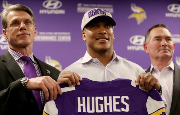 Minnesota Vikings first-round pick cornerback Mike Hughes from the University of Central Florida, with Vikings general manager Rick Spielman, left, an