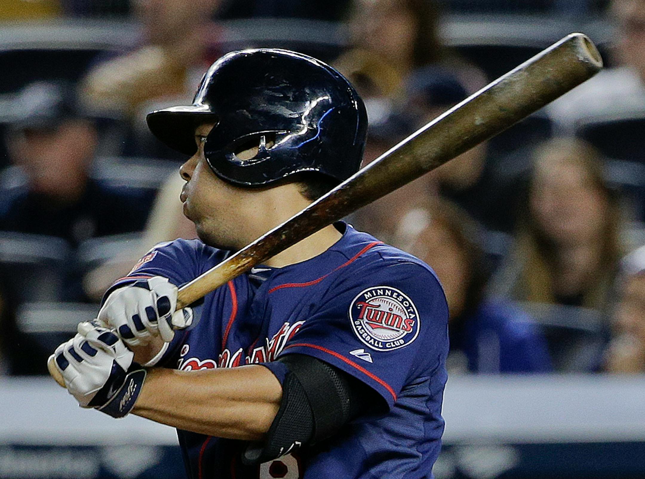 Minnesota Twins' Kurt Suzuki follows through on a base hit to right field to drive in a run against the New York Yankees during the eighth inning on Friday, May 30, 2014, in New York. The Yankees won 6-1. (AP Photo/Julie Jacobson)