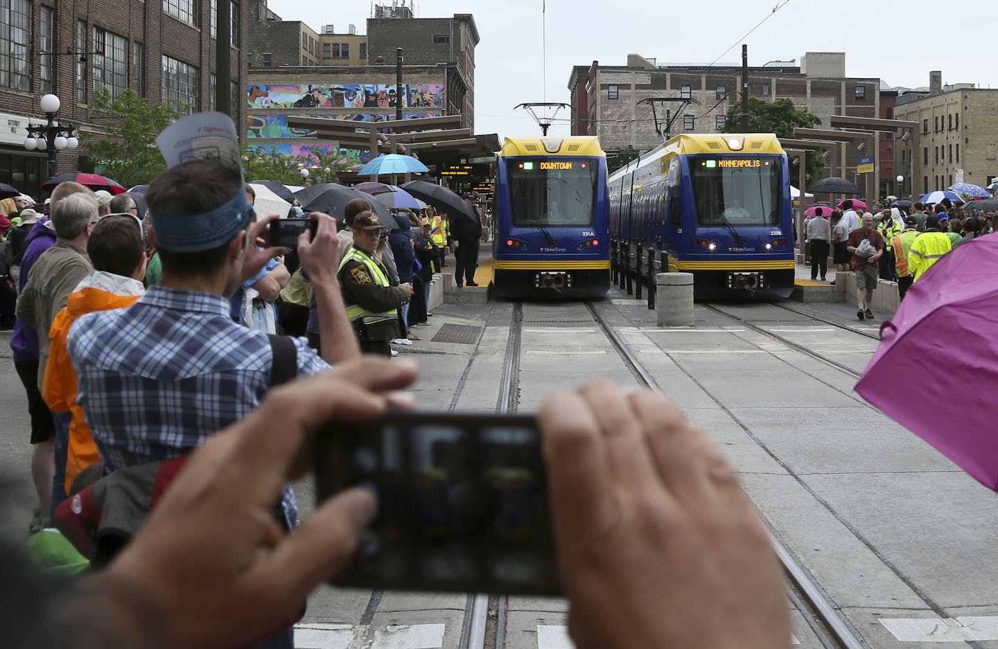 The first trains on the Greenline prepare to leave the station following an official ribbon cutting ceremony Saturday, June 14, 2014, at Union Station in St. Paul, MN.] (DAVIDJOLES/STARTRIBUNE) djoles@startribune.com After more than a decade of planning and nearly a billion dollars of public money, the Twin Cities' second light-rail line begins running Saturday as officials cut ribbons for the Green Line.