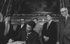 Gov. Wendell Anderson signed the omnibus tax bill in 1971. It was to raise about $580 million in new revenues. Watching, from left, were John Haynes, 