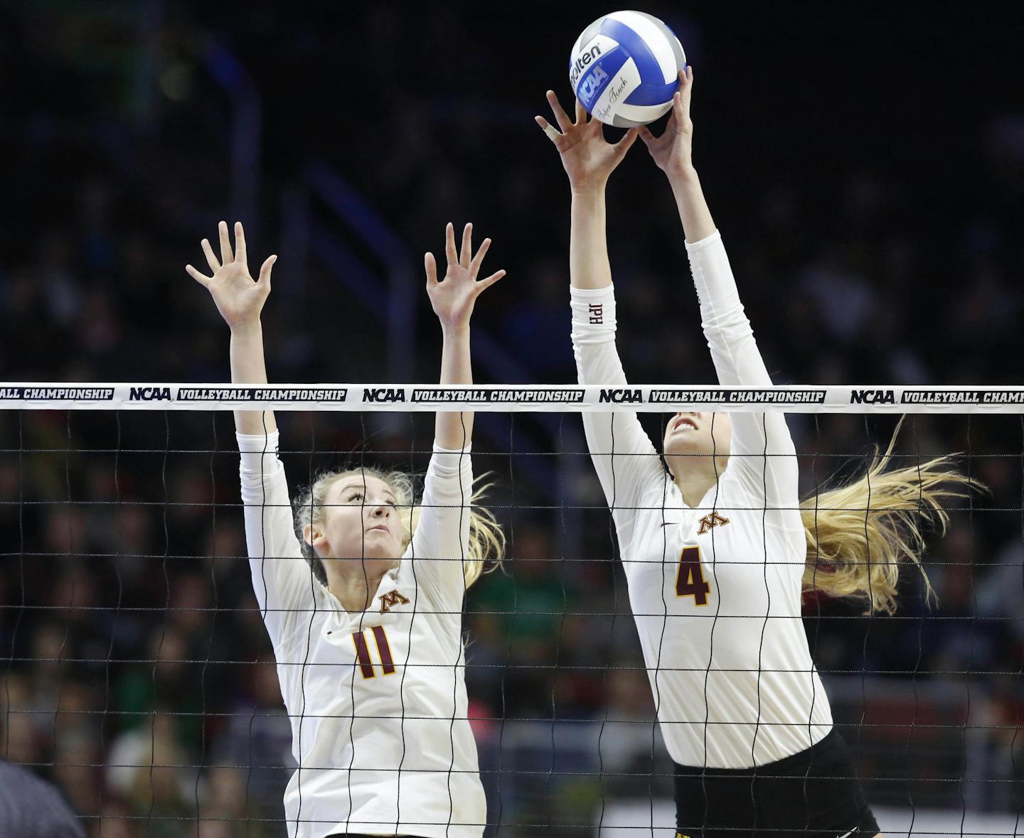 Minnesota's Samantha Seliger-Swenson (11) looks on as Minnesota's Paige Tapp (4) gets the block against Hawaii Saturday, Dec. 12, 2015, during the NCAA Division I Women's Volleyball Championship in Des Moines, Iowa. (The Des Moines Register, Michael Zamora/The Des Moines Register via AP)