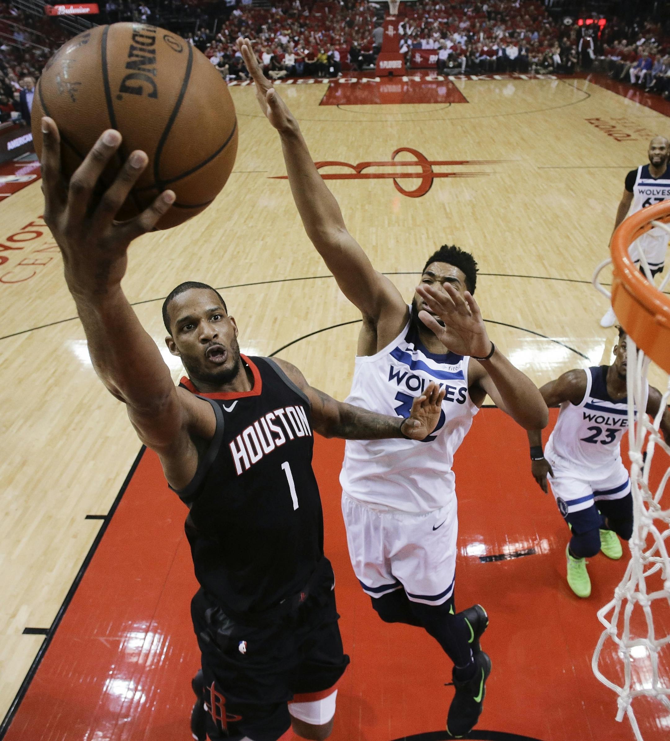 Houston Rockets forward Trevor Ariza (1) drives to the basket as Minnesota Timberwolves center Karl-Anthony Towns, right, defends during the first half in Game 5 of a first-round NBA basketball playoff series, Wednesday, April 25, 2018, in Houston.