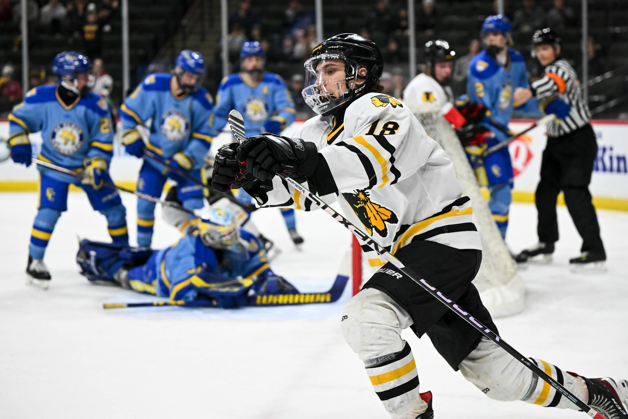 Warroad forward Carson Pilgrim (18) celebrates after scoring a goal against St. Cloud Cathedral goaltender Nick Hansen (31) during the first period.