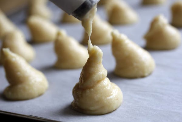 A pastry bag fitted with an open tip gives you consistency when dropping the dough.