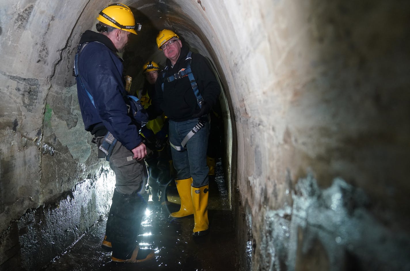 Danny Rohloff, construction management coordinator, showed Minneapolis Director of Public Works Robin Hutcheson and Gov. Tim Walz around a storm tunnel beneath the ground during a tour of the system in northeast Minneapolis Friday. ] ANTHONY SOUFFLE &#x2022; anthony.souffle@startribune.com Gov. Tim Walz and Myron Frans, commissioner of Minnesota Management and Budget, toured a municipal storm tunnel after he unveiled the second piece of his bonding package focusing on water quality Friday, Jan.