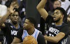 Sacramento forward Rudy Gay, center, is double-teamed by Minnesota's Andrew Wiggins, left, and Karl-Anthony Towns.