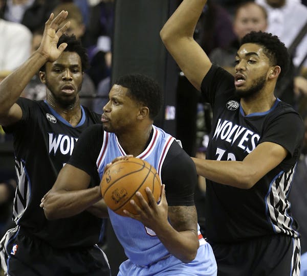 Sacramento forward Rudy Gay, center, is double-teamed by Minnesota's Andrew Wiggins, left, and Karl-Anthony Towns.