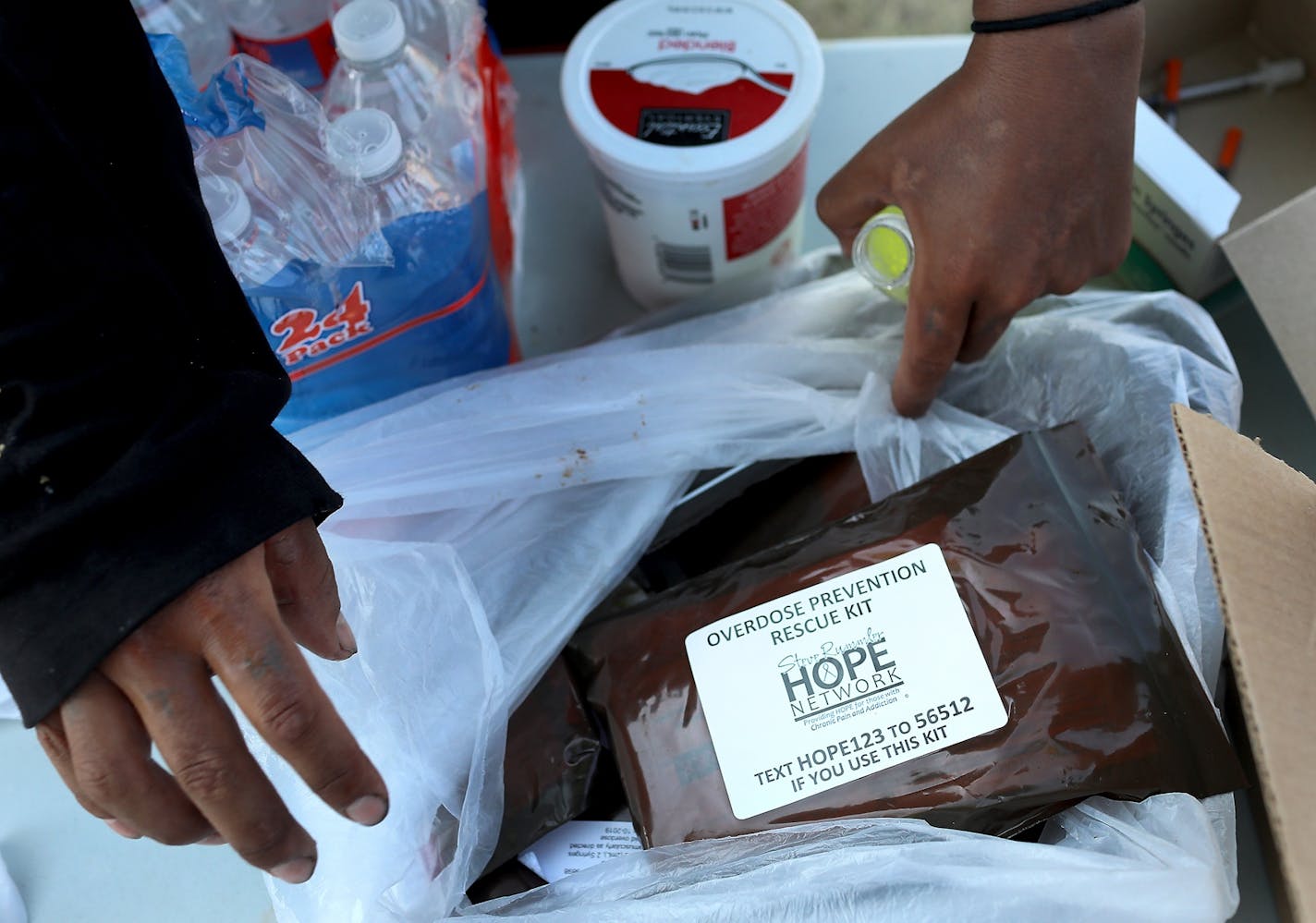 Bags of Narcan kits were also available in a dinner line sponsored by Natives Against Heroin at a homeless encampment near Hiawatha and Cedar Avenues Wednesday, Aug. 8, 2018, in Minneapolis, MN.