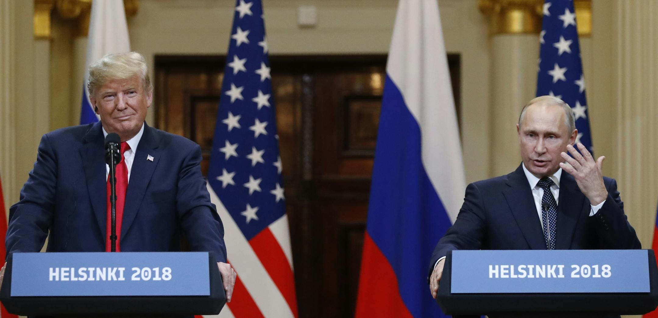 U.S. President Donald Trump, left, listens to Russian President Vladimir Putin during a press conference after their meeting at the Presidential Palace in Helsinki, Finland, Monday, July 16, 2018. (AP Photo/Alexander Zemlianichenko)