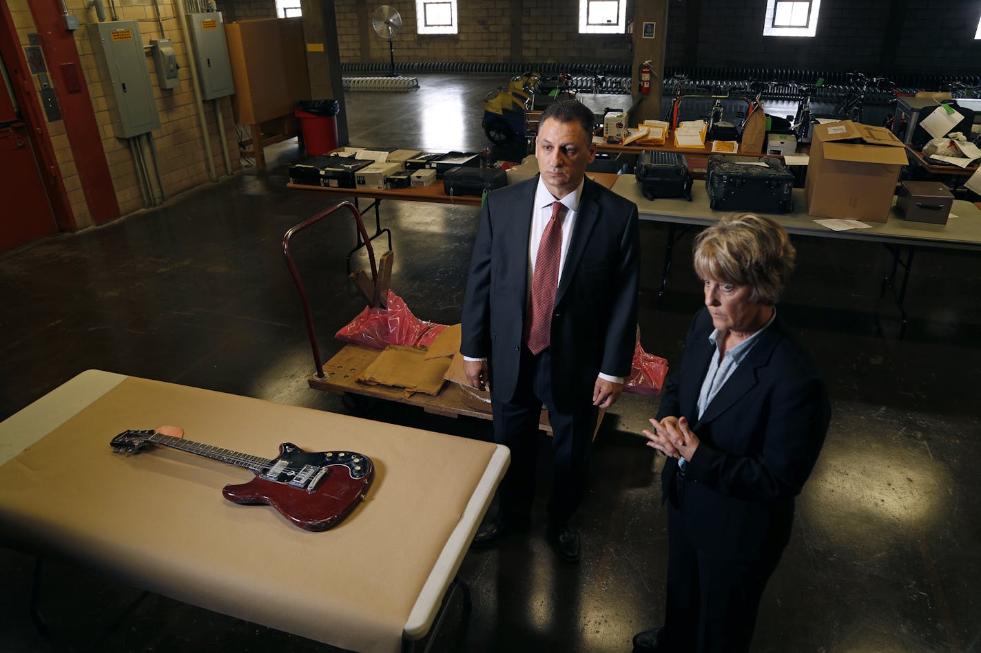 Sgt. Chris Karkostas, left, is investigating Joseph Behrend's death with the help of now retired Sgt. Jane Moore, who helped start the Cold Case Squad. Evidence includes files on Behrend's death and the weapon, his red Epiphone guitar.