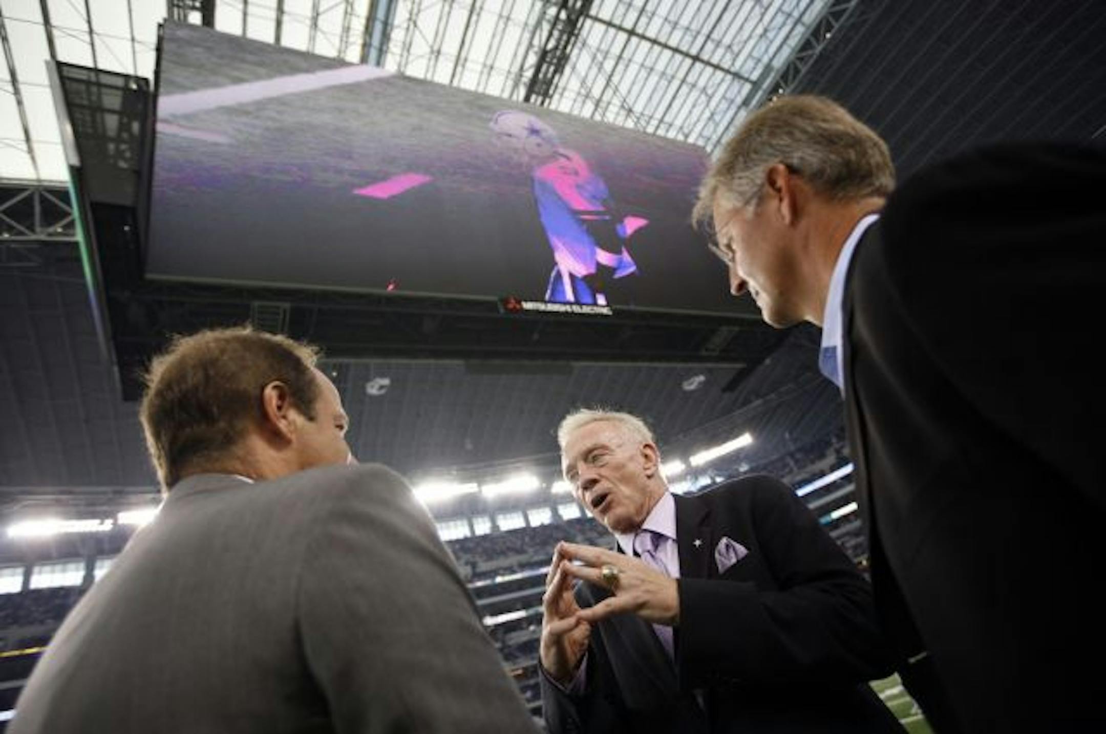 ARLINGTON, TX - AUGUST 21: Dallas Cowboys team owner Jerry Jones (center) talks with two unidentified individuals before the Cowboys take on the Tennessee Titans during a preseason game at Dallas Cowboys Stadium on August 21, 2009 in Arlington, Texas.