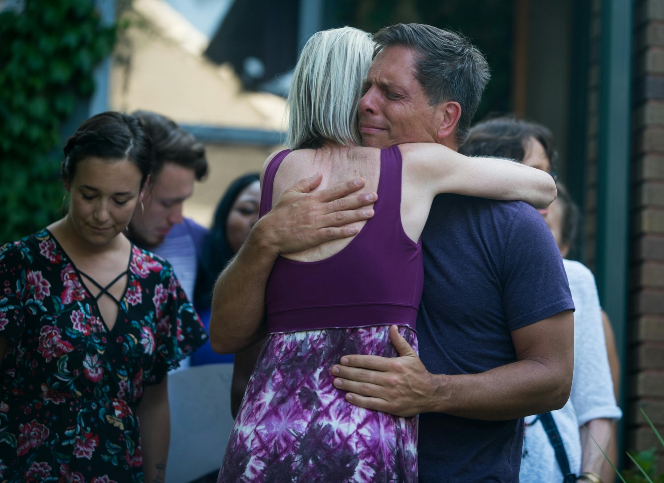 Don Damond, the fianc� of Justine Damond, was comforted outside his home as demonstrators marched by Damond's home during the Peace and Justice March for Justine Thursday.