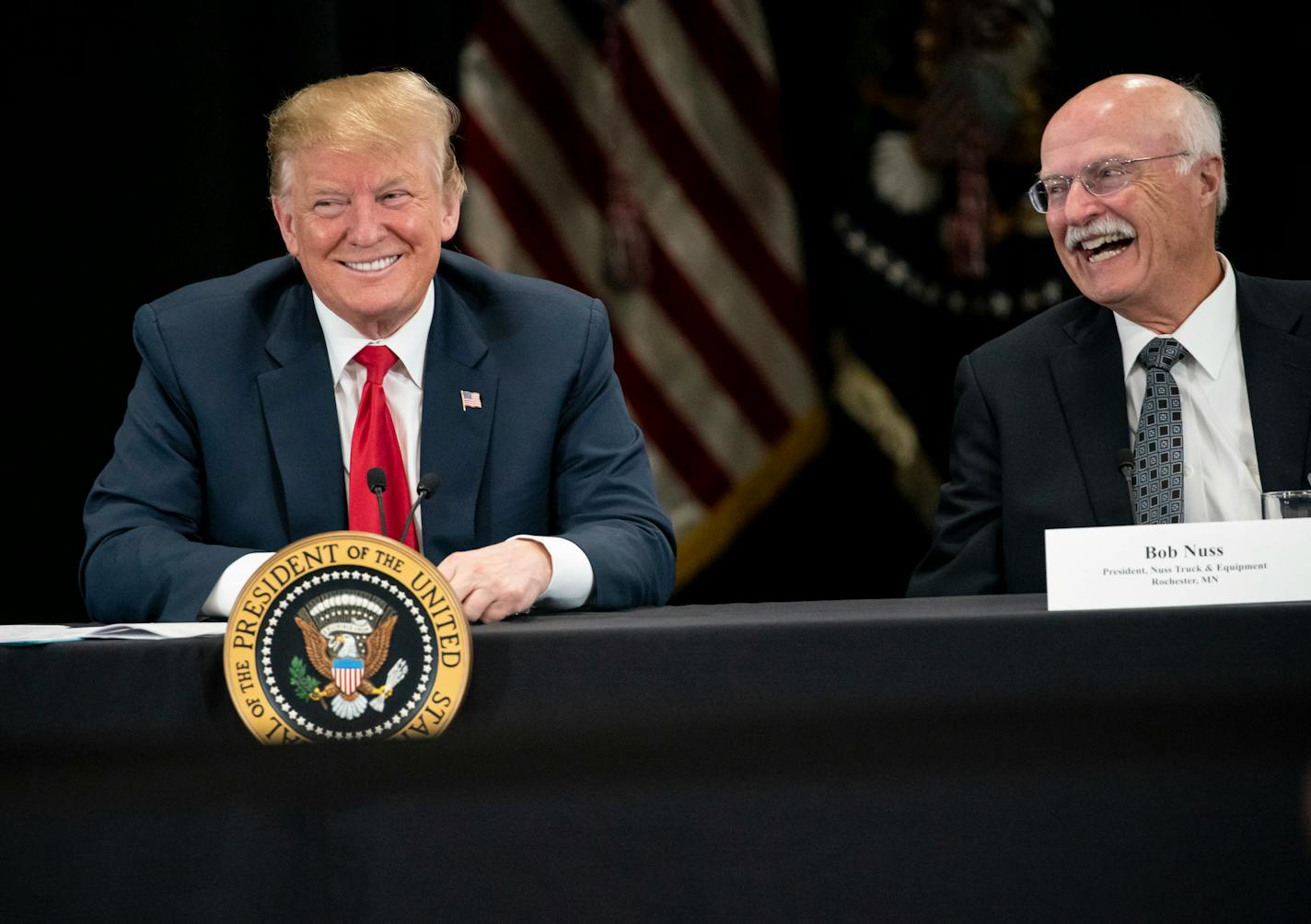 President Donald J. Trump speaks at Nuss Truck and Equipment in Burnsville during a roundtable discussion on tax cuts and the U.S. economy Monday in Burnsville. At right is the president of Nuss Truck and Equipment, Bob Nuss.