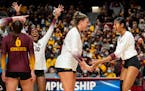 University of Minnesota setter Melani Shaffmaster (5) and outside Airi Miyabe (8) celebrate winning a point in the first set against the University of