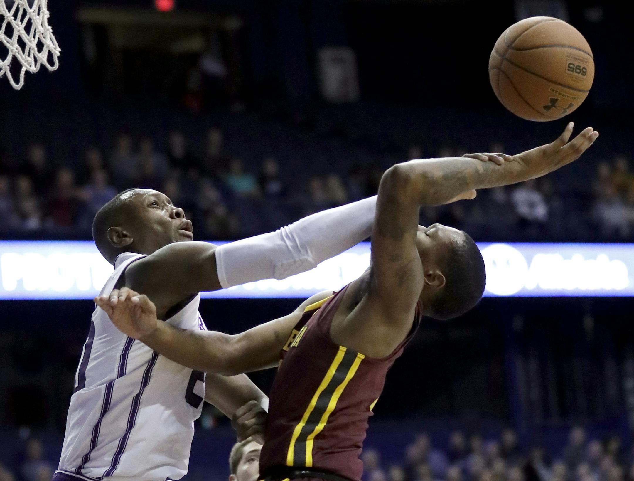 Northwestern guard Scottie Lindsey, left, blocks a shot by Minnesota guard Dupree McBrayer during the first half of an NCAA college basketball game Wednesday, Jan. 10, 2018, in Rosemont, Ill. (AP Photo/Nam Y. Huh)