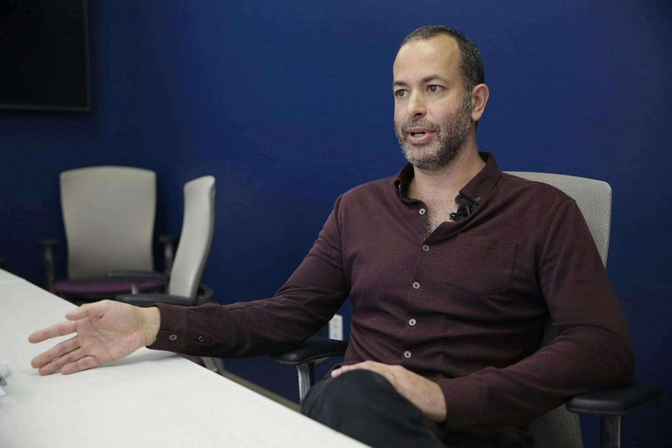 In this photo taken Friday, Sept. 18, 2015, Metabiota Inc. founder Nathan Wolfe speaks during an interview at his offices in San Francisco. Wolfe has focused his company's work on disease hotspots like West Africa in a bid to sniff out the next big threat. In the early months of the Ebola outbreak, Metabiota was one of the first to assist the Sierra Leonean government with disease surveillance, training and lab testing. Within a few months, scientists from the World Health Organization, the Unit