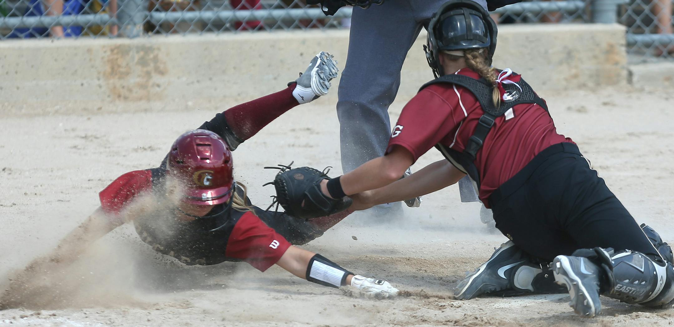 Lakeville South's Michaela Thielen slid safely into home plate for the go ahead run against Maple Grove catcher Jordan Mauch in the sixth innning ] (KYNDELL HARKNESS/STAR TRIBUNE) kyndell.harkness@startribune.com Class 3A softball state Championship Lakeville South 4, Maple Grove 3 in North Mankato, Min. Friday, June 6, 2014.
