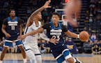 Timberwolves guard Jarrett Culver drives against Memphis guard Ja Morant during the first half of a game Tuesday